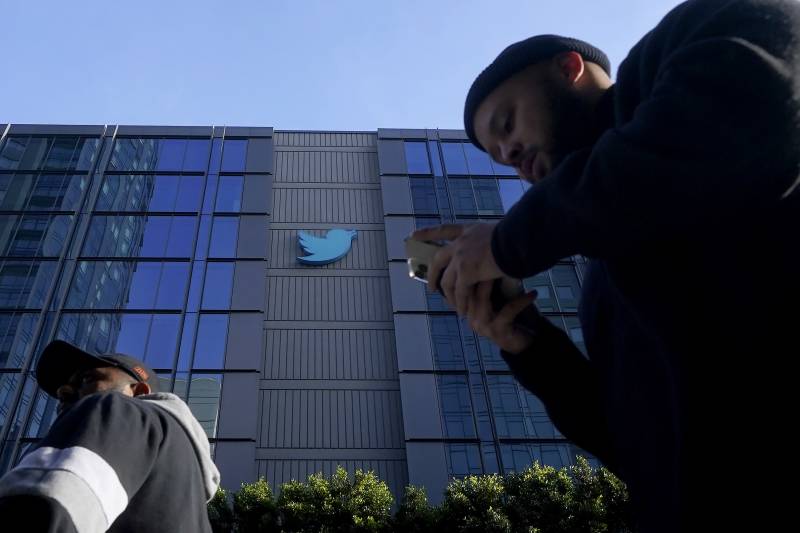 People walk outside Twitter headquarters in San Francisco, Friday, Nov. 4, 2022.
Employees were bracing for widespread layoffs at Twitter on Friday, as new owner... People walk outside Twitter headquarters in San Francisco, Friday, Nov. 4, 2022.
Employees were bracing for widespread layoffs at Twitter on Friday, as new owner...